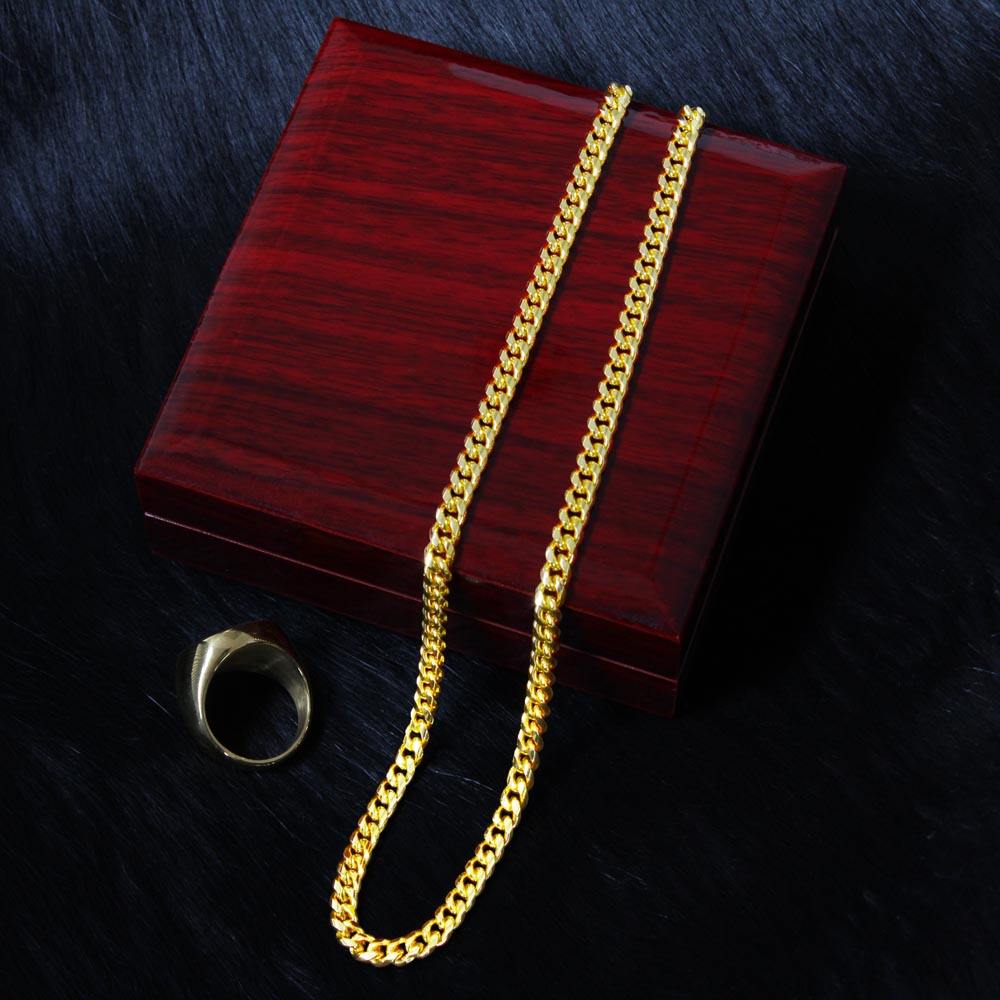 Men's Gold Cuban Link Chain Necklace Laying Across Gift Box